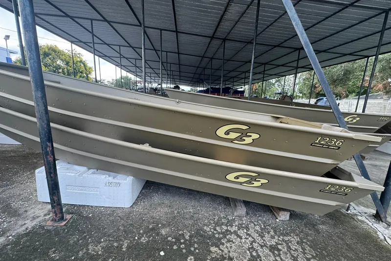 Slide: The Image of 2026 G3 Gator Tough 1436 boats stacked under a metal canopy. - 4
