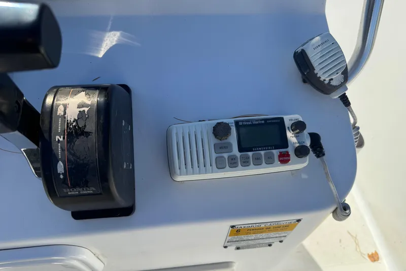 Slide: The Image of Boat control panel with radio and throttle on a 2003 Mako 192 Center Console. - 3