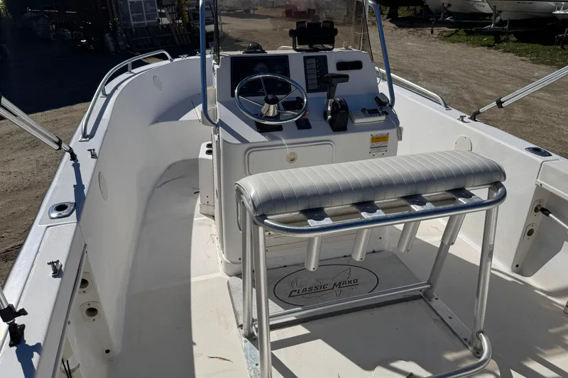 Slide: The Image of 2003 Mako 192 Center Console boat interior with steering wheel and seating. - 5
