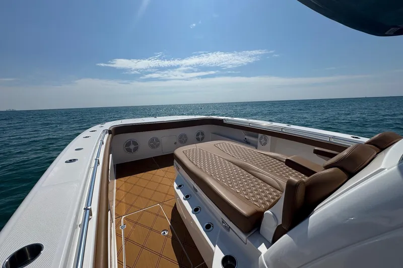 Slide: The Image of Luxurious 2024 Invincible 46 Catamaran with elegant seating, cruising on open sea. - 13