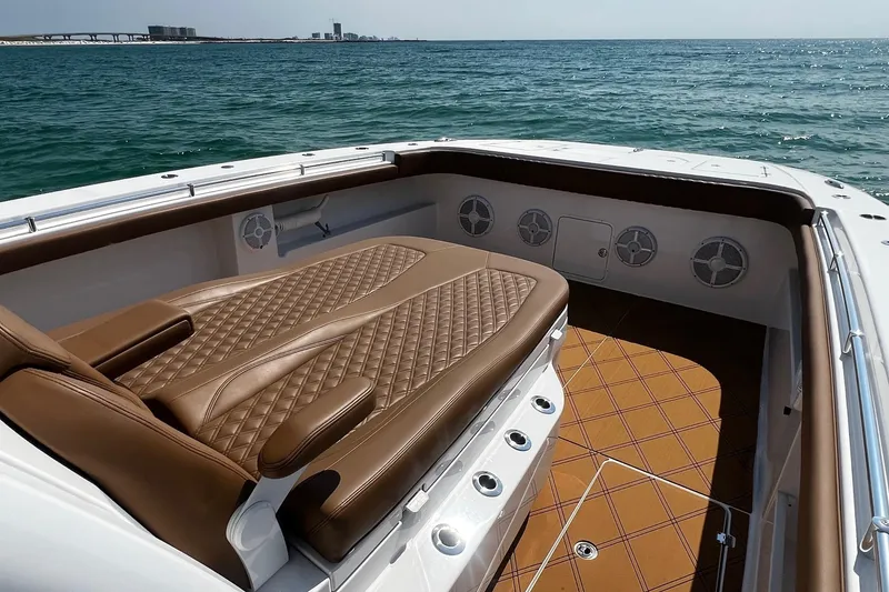 Slide: The Image of Luxurious seating on 2024 Invincible 46 Catamaran, featuring elegant brown upholstery and ocean view. - 17