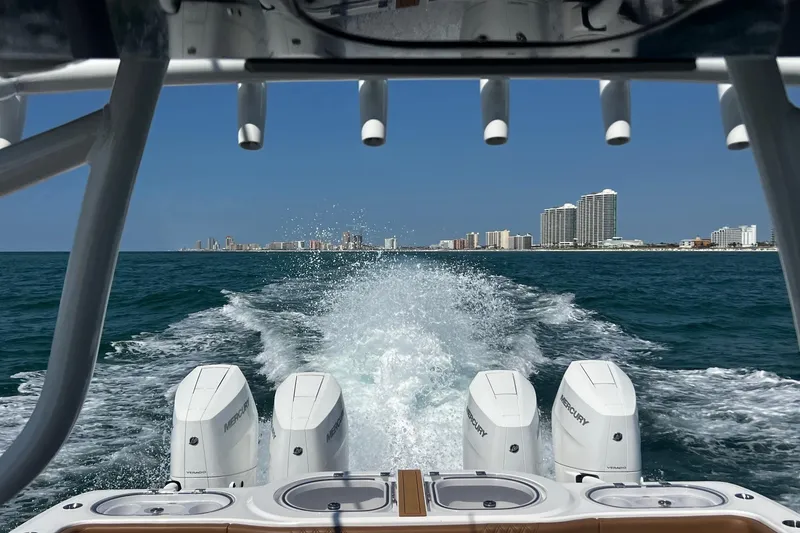 Slide: The Image of 2024 Invincible 46 Catamaran cruising with city skyline in the background. - 22