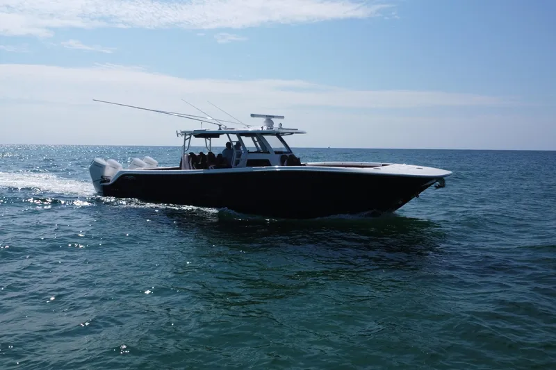 Slide: The Image of 2024 Invincible 46 Catamaran cruising on open water under clear skies. - 29