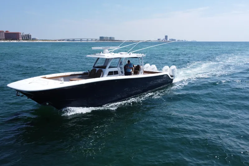 Slide: The Image of 2024 Invincible 46 Catamaran cruising on open water, showcasing sleek design and performance. - 33