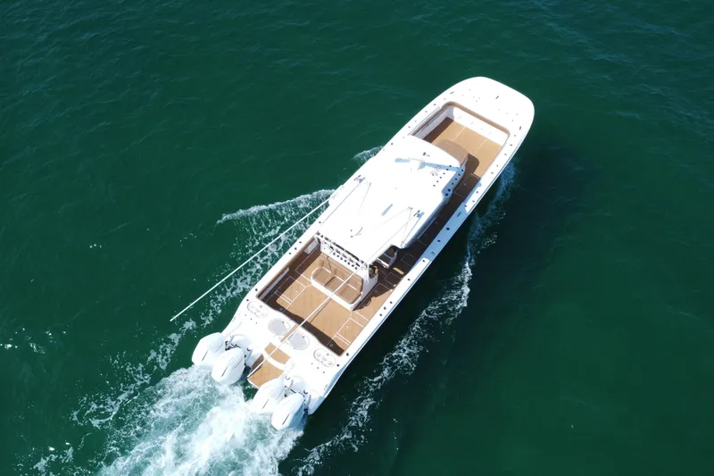 Slide: The Image of 2024 Invincible 46 Catamaran cruising on open water, aerial view. - 37
