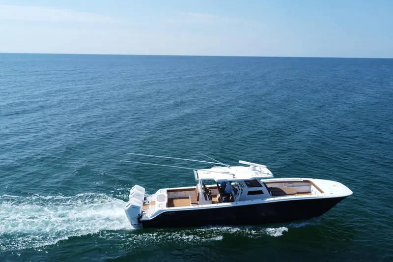 Slide: The Image of 2024 Invincible 46 Catamaran cruising on open sea under clear blue sky. - 38