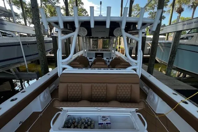 Slide: The Image of 2024 Invincible 46 Catamaran with luxurious seating and modern amenities docked in a marina. - 44