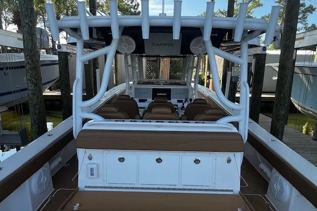 Slide: The Image of 2024 Invincible 46 Catamaran with Garmin electronics, docked, featuring spacious seating and storage. - 45