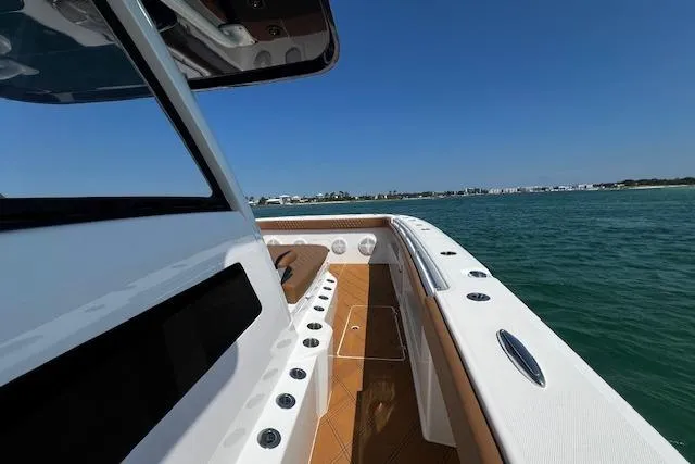 Slide: The Image of 2024 Invincible 46 Catamaran on water, showcasing sleek deck design and ocean view. - 47