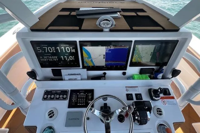 Slide: The Image of 2024 Invincible 46 Catamaran helm with navigation screens and controls. - 50