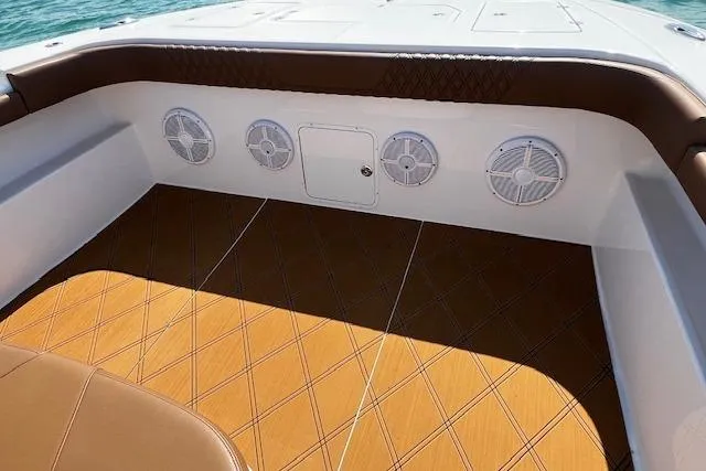 Slide: The Image of 2024 Invincible 46 Catamaran interior with stylish seating and marine speakers. - 52