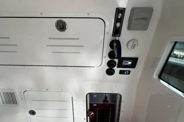 Slide: The Image of 2024 Invincible 46 Catamaran interior control panel with gauges and storage compartments. - 57