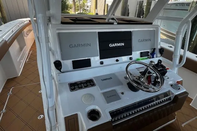 Slide: The Image of 2024 Invincible 46 Catamaran helm with Garmin displays and steering wheel. - 58