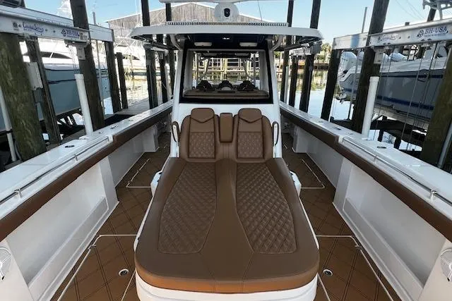 Slide: The Image of 2024 Invincible 46 Catamaran interior with luxurious brown seating and spacious deck. - 62