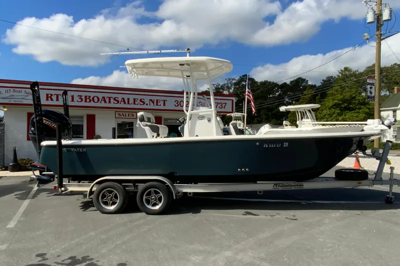 The Image of 2022 Tidewater 2300 Carolina Bay boat on trailer at dealership, clear sky background. - 1