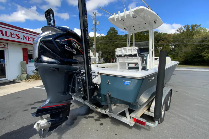 Slide: The Image of 2022 Tidewater 2300 Carolina Bay boat on trailer, featuring a powerful outboard motor. - 10