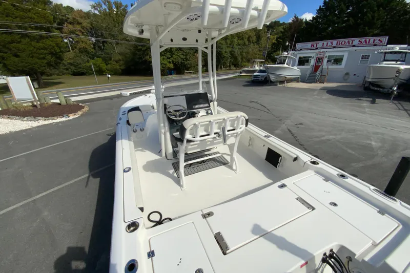 Slide: The Image of 2022 Tidewater 2300 Carolina Bay boat at dealership, featuring spacious deck and modern console. - 11