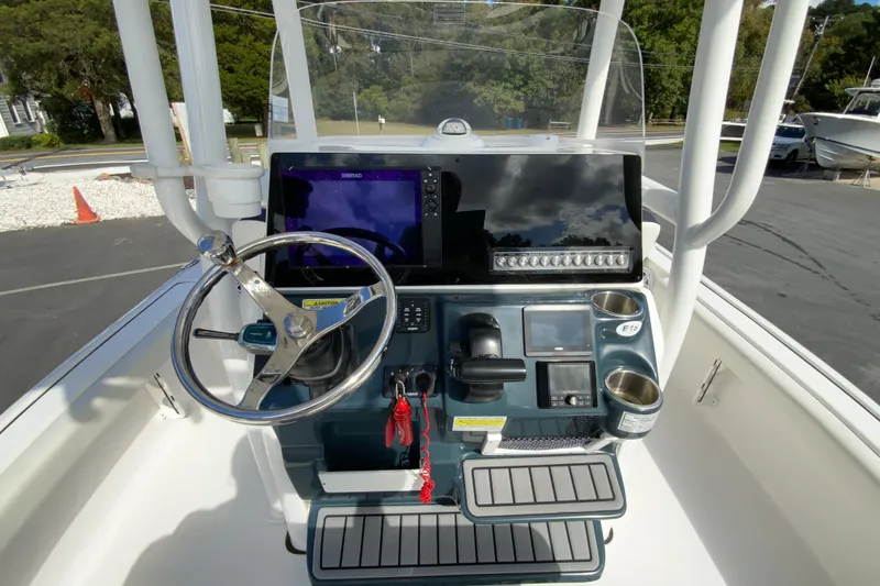 Slide: The Image of 2022 Tidewater 2300 Carolina Bay boat console with steering wheel and navigation display. - 12