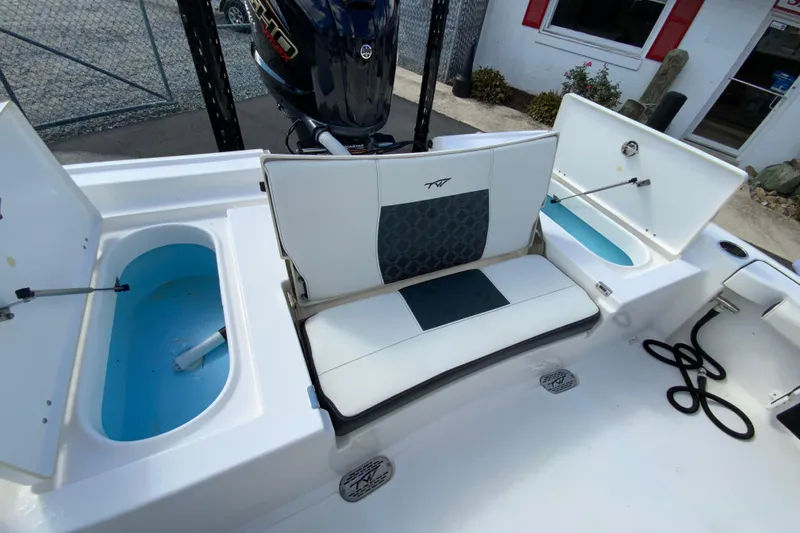 Slide: The Image of 2022 Tidewater 2300 Carolina Bay boat interior with seating and storage compartments. - 18