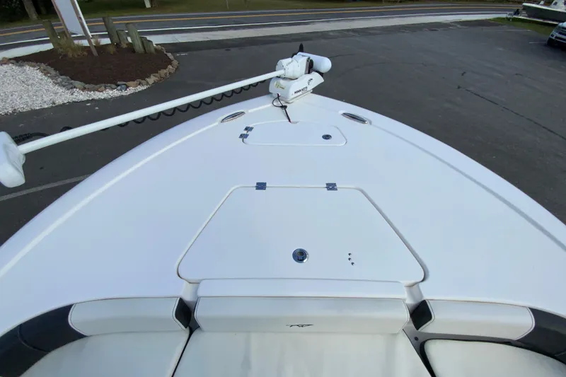 Slide: The Image of 2022 Tidewater 2300 Carolina Bay boat deck with storage compartments and trolling motor. - 21