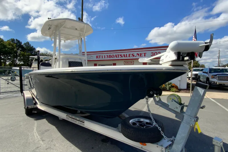 Slide: The Image of 2022 Tidewater 2300 Carolina Bay boat on trailer at dealership, under clear blue sky. - 3