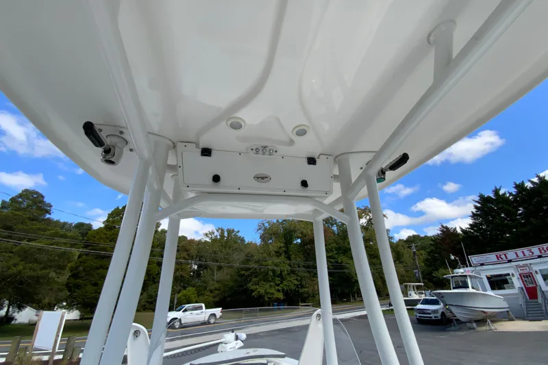 Slide: The Image of 2022 Tidewater 2300 Carolina Bay boat T-top view with clear sky background. - 32