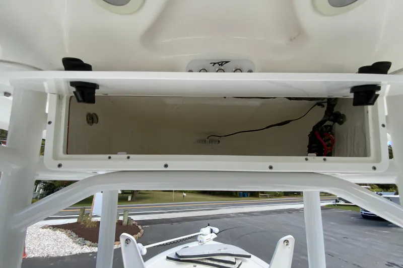 Slide: The Image of 2022 Tidewater 2300 Carolina Bay boat storage compartment, open and empty, with visible wiring. - 33
