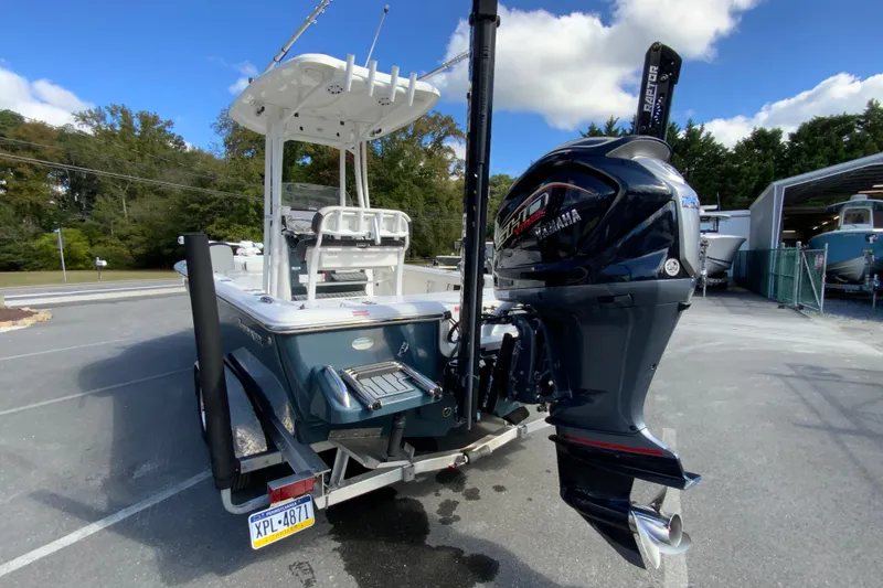 Slide: The Image of 2022 Tidewater 2300 Carolina Bay boat with Yamaha outboard motor, parked outdoors. - 8