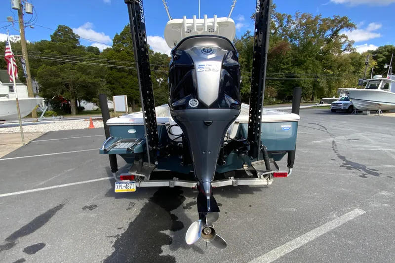 Slide: The Image of 2022 Tidewater 2300 Carolina Bay boat with powerful outboard motor, parked in a lot. - 9