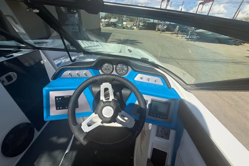 Slide: The Image of 2021 MasterCraft NXT24 boat dashboard with steering wheel and control panel. - 11