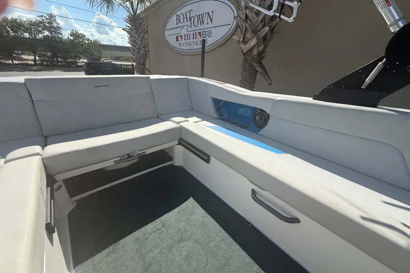 Slide: The Image of 2021 MasterCraft NXT24 boat interior with white seating and blue accents. - 16