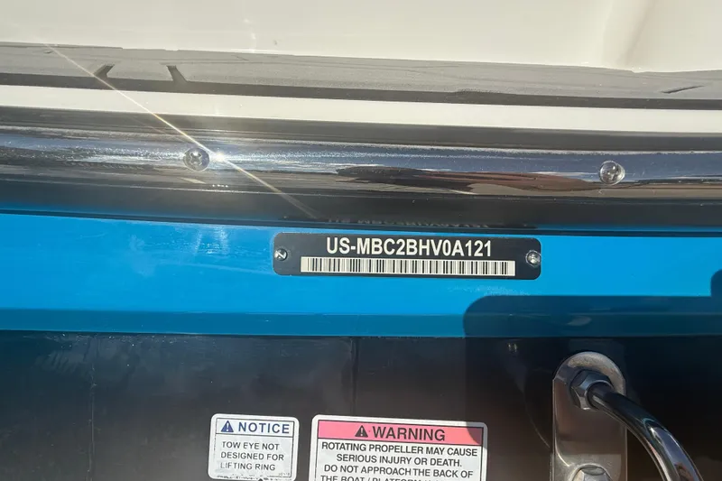 Slide: The Image of 2021 MasterCraft NXT24 boat identification number and safety warnings displayed on the hull. - 18
