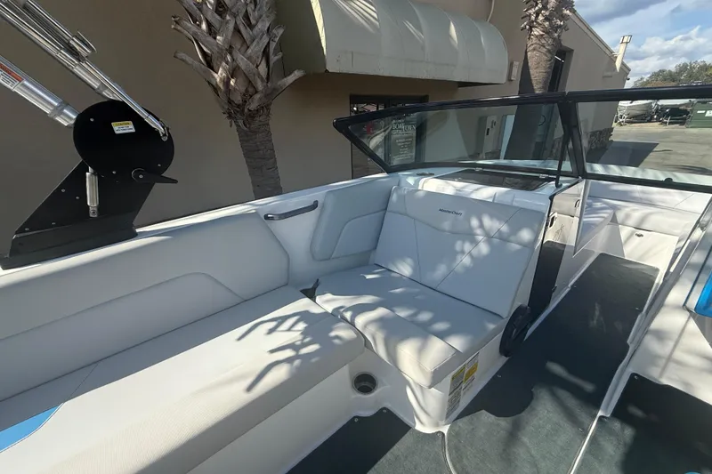 Slide: The Image of 2021 MasterCraft NXT24 boat interior with white seating and open deck layout. - 9
