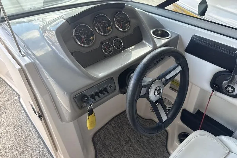Slide: The Image of 2018 Chaparral 21 H2O Sport boat dashboard with steering wheel and gauges. - 12
