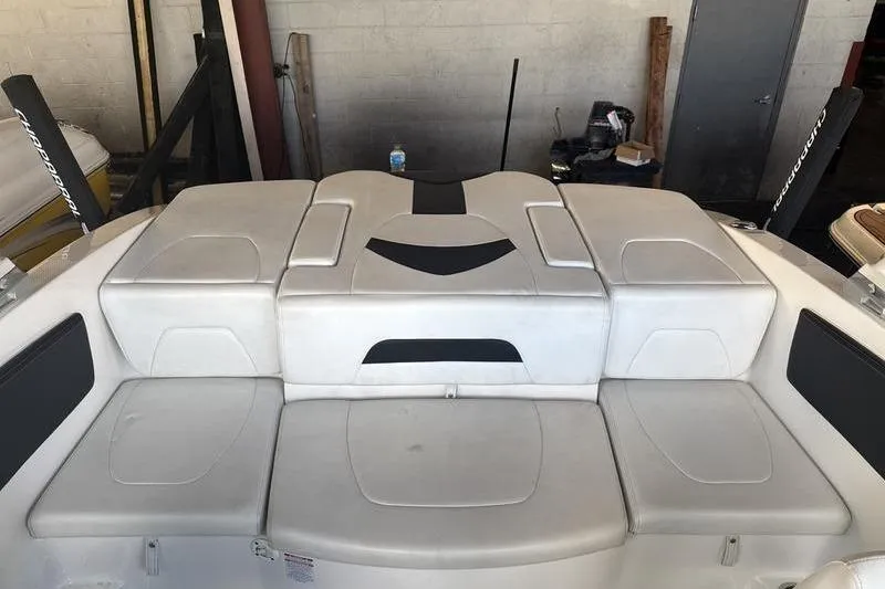 Slide: The Image of 2018 Chaparral 21 H2O Sport boat interior with cushioned seating. - 14