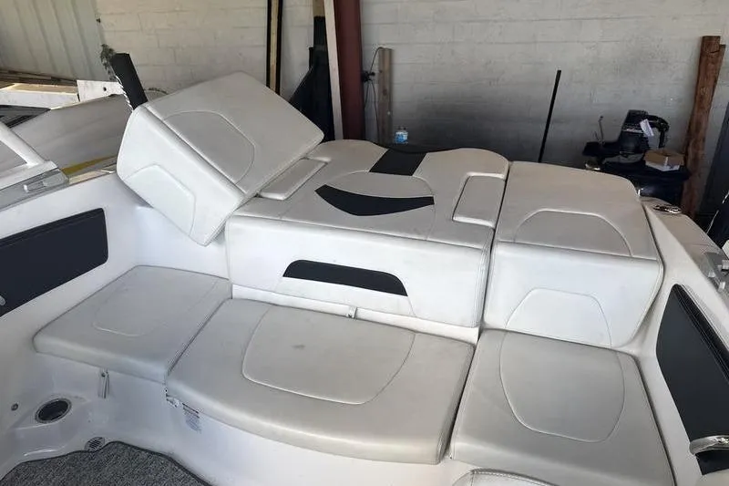 Slide: The Image of 2018 Chaparral 21 H2O Sport boat interior with white cushioned seating. - 15