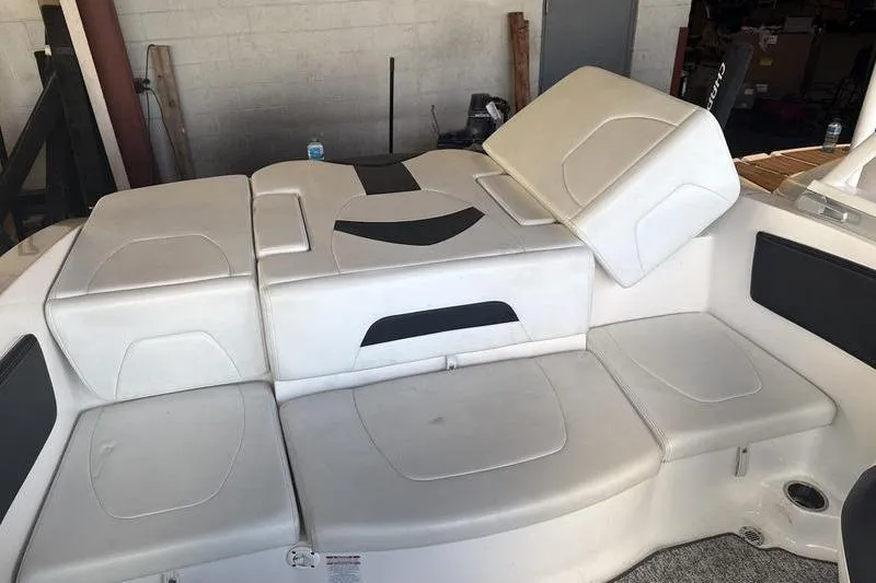 Slide: The Image of 2018 Chaparral 21 H2O Sport boat interior seating with white and black upholstery. - 16