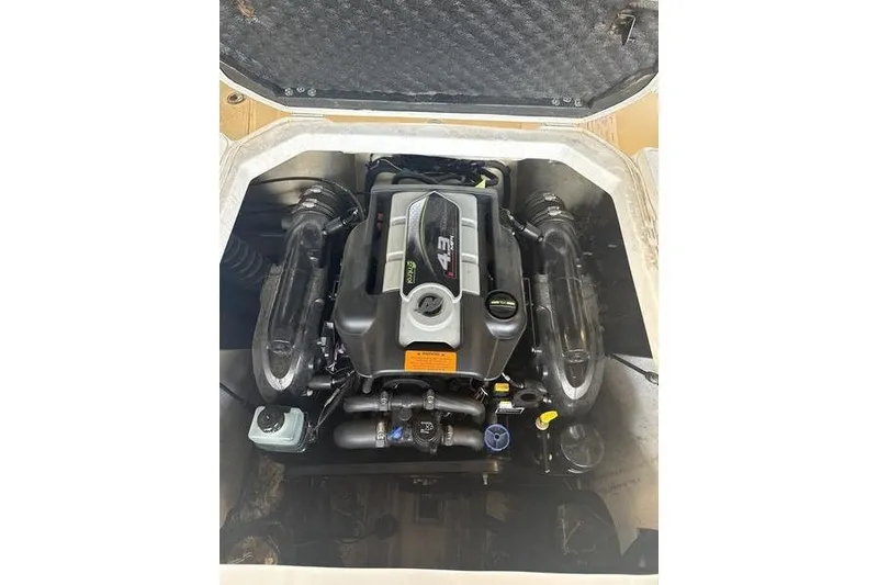 Slide: The Image of 2018 Chaparral 21 H2O Sport engine compartment showcasing a powerful inboard motor. - 18