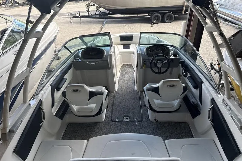 Slide: The Image of 2018 Chaparral 21 H2O Sport boat interior with seating and steering wheel. - 19