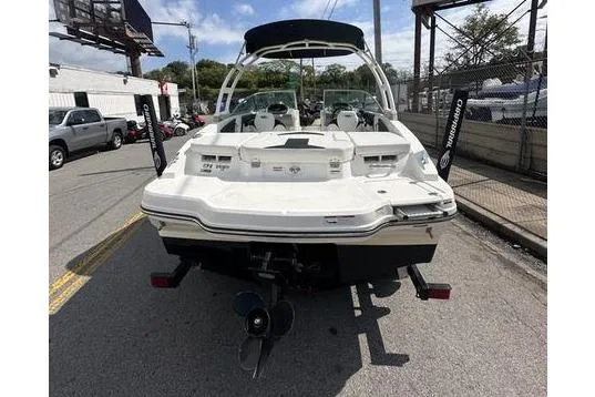 Slide: The Image of 2018 Chaparral 21 H2O Sport boat, rear view on street, showcasing sleek design. - 20