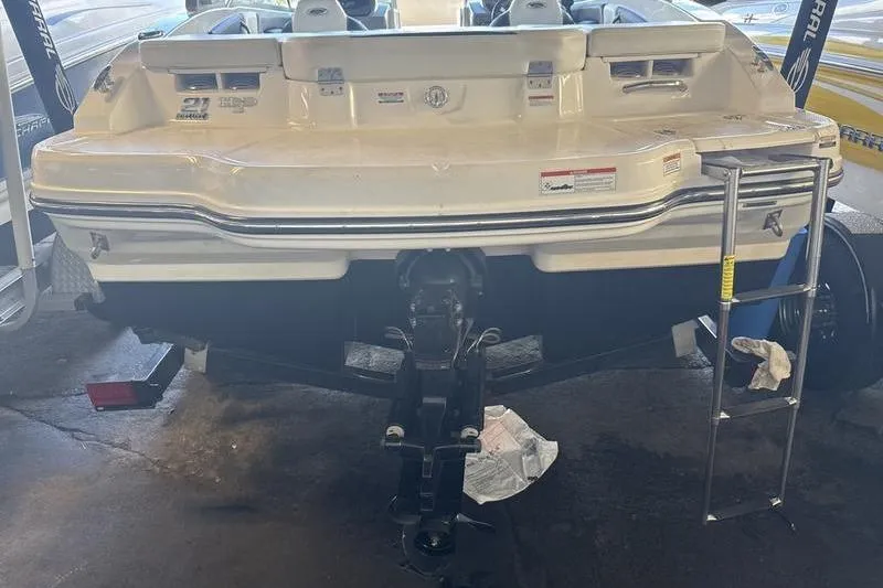 Slide: The Image of 2018 Chaparral 21 H2O Sport boat rear view with ladder and outboard motor. - 21