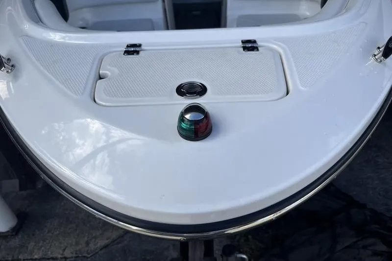 Slide: The Image of 2018 Chaparral 21 H2O Sport boat bow with navigation light and hatch. - 3