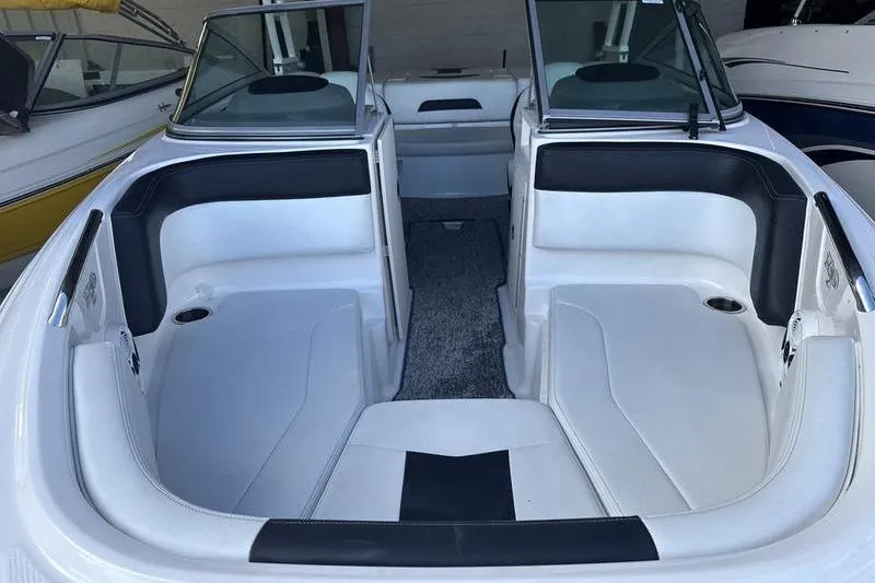 Slide: The Image of 2018 Chaparral 21 H2O Sport boat interior with white and black seating. - 4