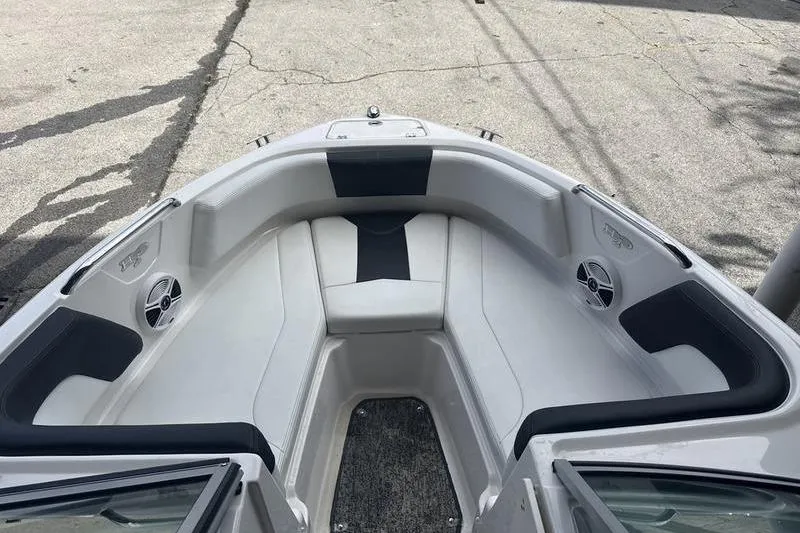 Slide: The Image of 2018 Chaparral 21 H2O Sport boat interior with cushioned seating and speakers. - 5