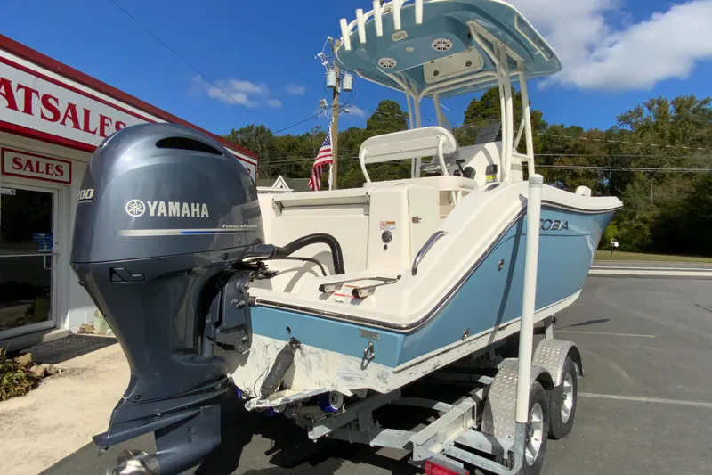 Slide: The Image of 2021 Cobia 220 Center Console boat with Yamaha engine on trailer, parked outside sales building. - 10