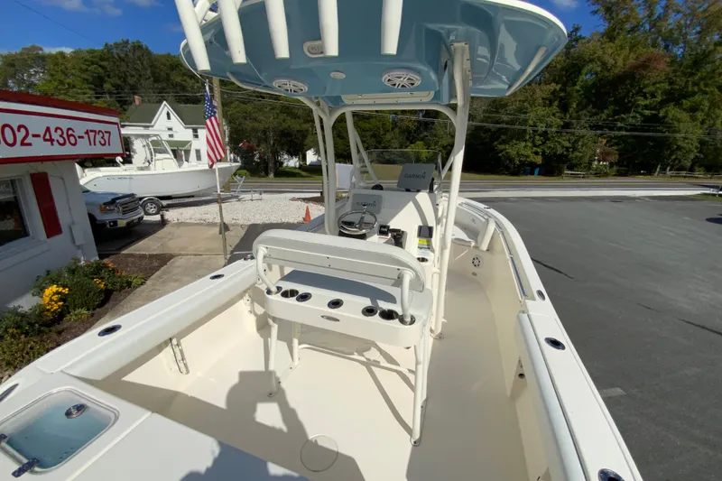 Slide: The Image of 2021 Cobia 220 Center Console boat with T-top and fishing rod holders. - 11