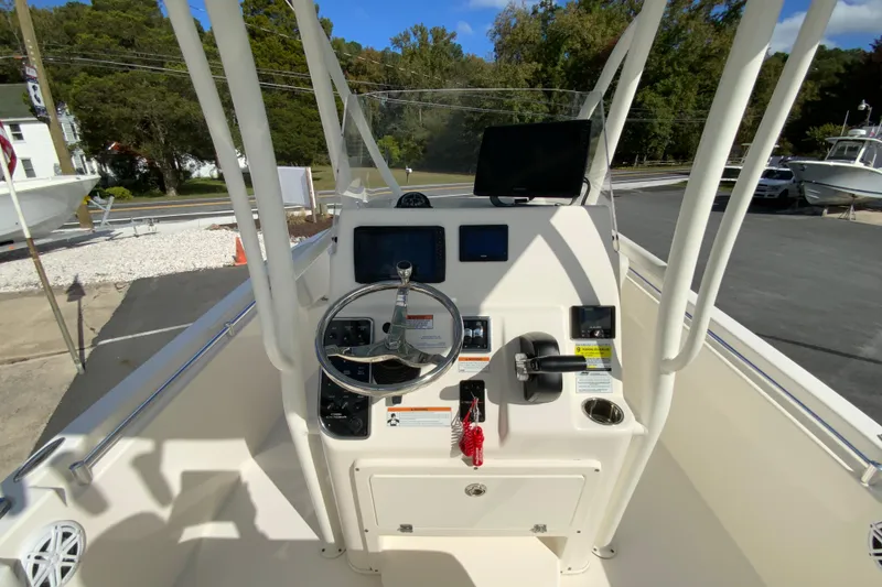 Slide: The Image of 2021 Cobia 220 Center Console boat dashboard with steering wheel and controls. - 13