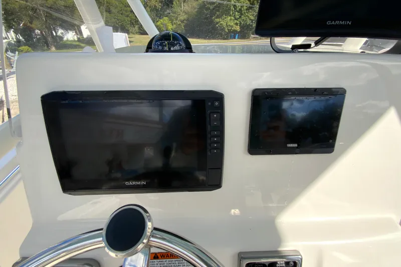 Slide: The Image of 2021 Cobia 220 Center Console dashboard with Garmin and Yamaha displays. - 15