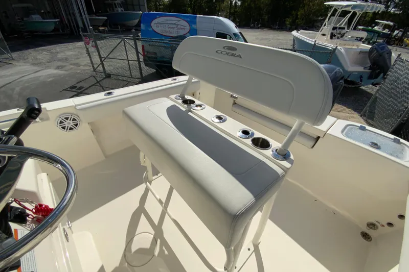 Slide: The Image of 2021 Cobia 220 Center Console boat interior with seating and rod holders. - 17