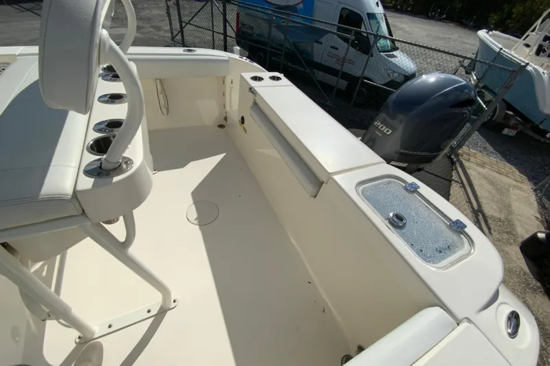 Slide: The Image of 2021 Cobia 220 Center Console boat interior with seating and engine view. - 19